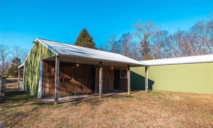 View of outbuilding featuring a lawn