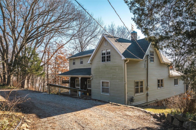 Rear view of property featuring covered porch
