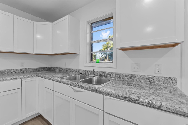 Kitchen with white cabinetry and sink