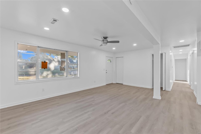 Unfurnished living room with light hardwood / wood-style floors and ceiling fan