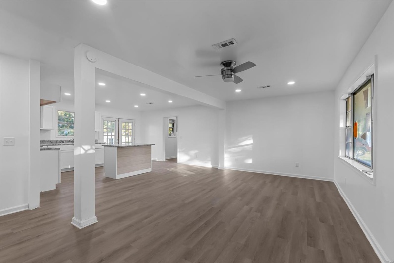 Unfurnished living room with dark hardwood / wood-style floors and ceiling fan