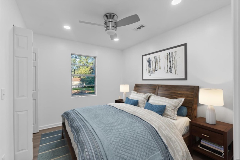 Bedroom with ceiling fan and dark hardwood / wood-style flooring