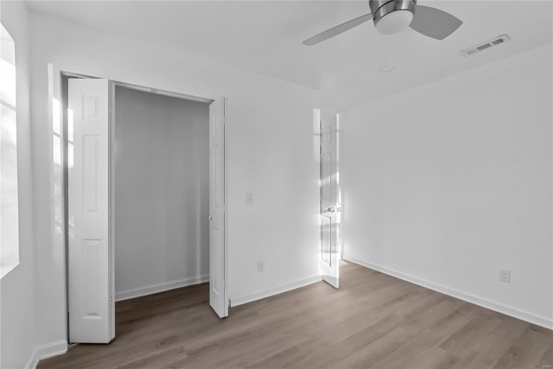 Unfurnished bedroom with ceiling fan, light hardwood / wood-style flooring, and a closet