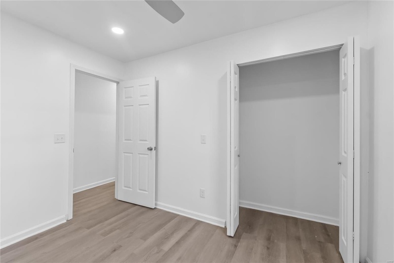 Unfurnished bedroom with light hardwood / wood-style floors and ceiling fan