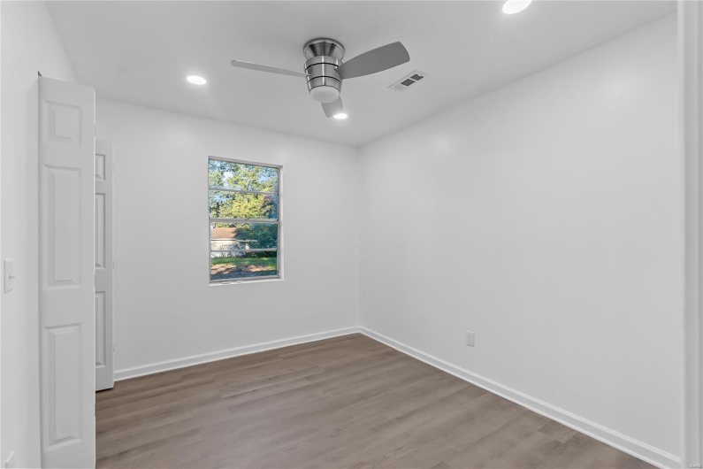Unfurnished room featuring ceiling fan and hardwood / wood-style flooring