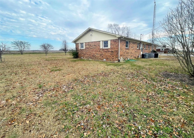 View of side of property featuring a lawn