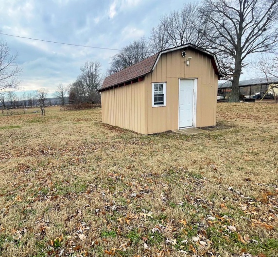 View of outdoor structure with a lawn