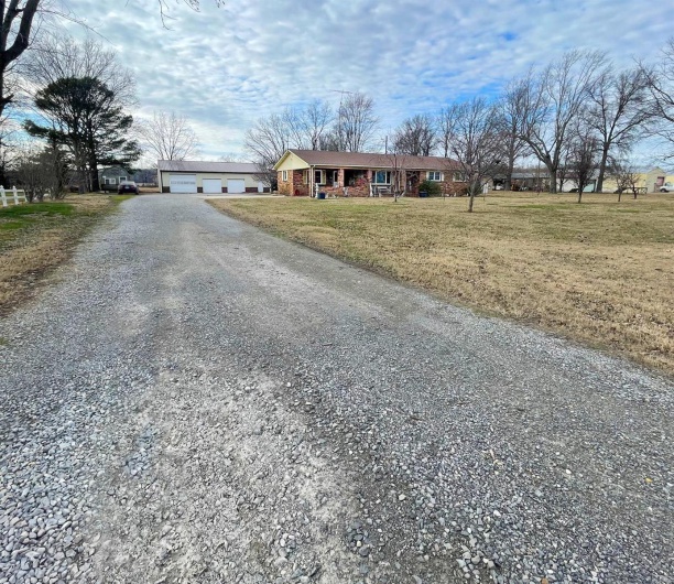 View of front of property featuring a garage and a front yard