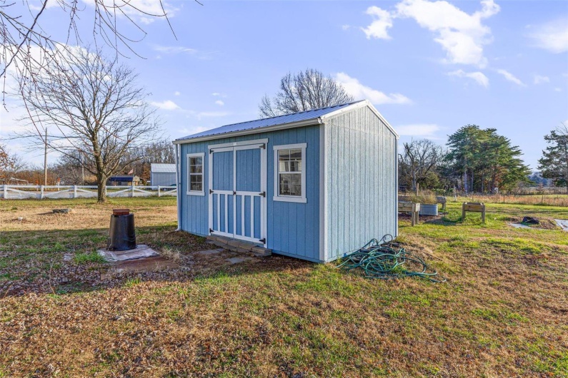 View of outbuilding with a yard