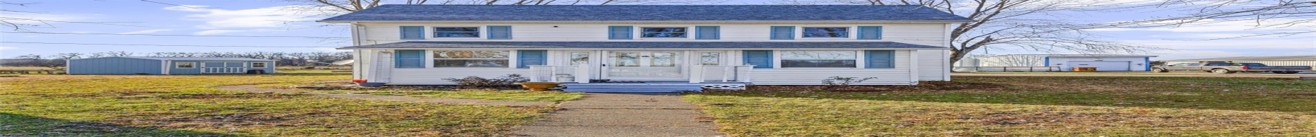 Residential For Sale View of front of house with a front lawn and a shed