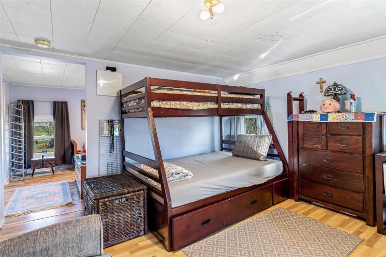 Bedroom with light hardwood / wood-style flooring