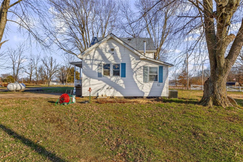 View of home's exterior with a yard and central air condition unit