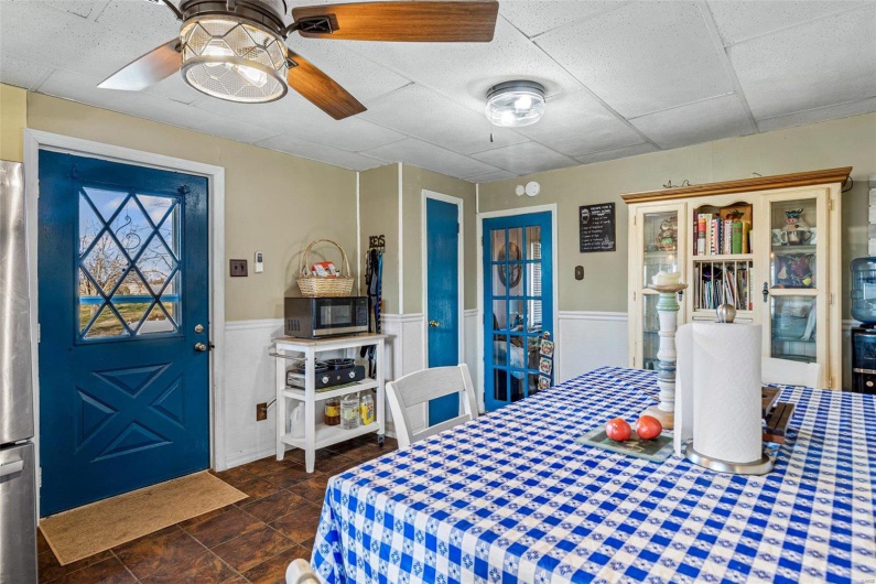 Dining area with a drop ceiling and ceiling fan