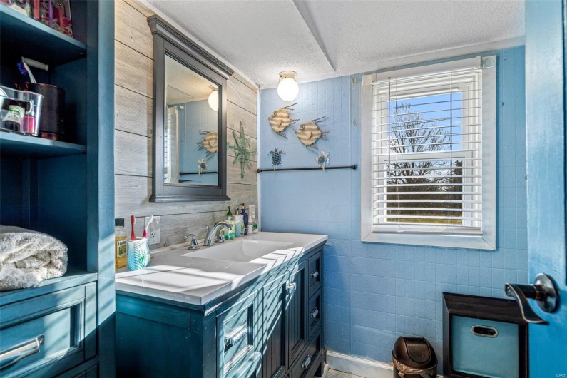 Bathroom featuring a textured ceiling and vanity