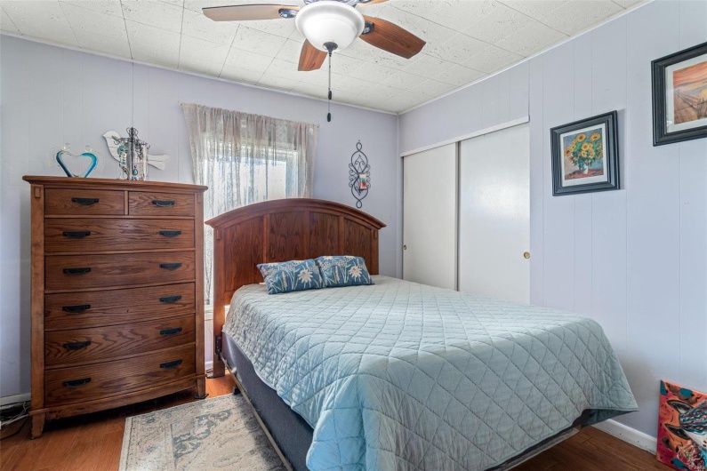 Bedroom featuring a closet, hardwood / wood-style flooring, and ceiling fan