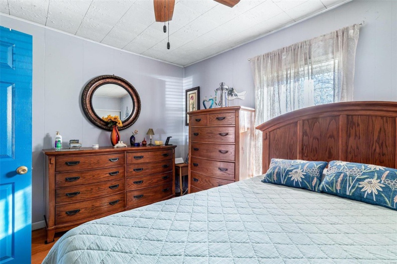 Bedroom featuring ceiling fan and wood-type flooring