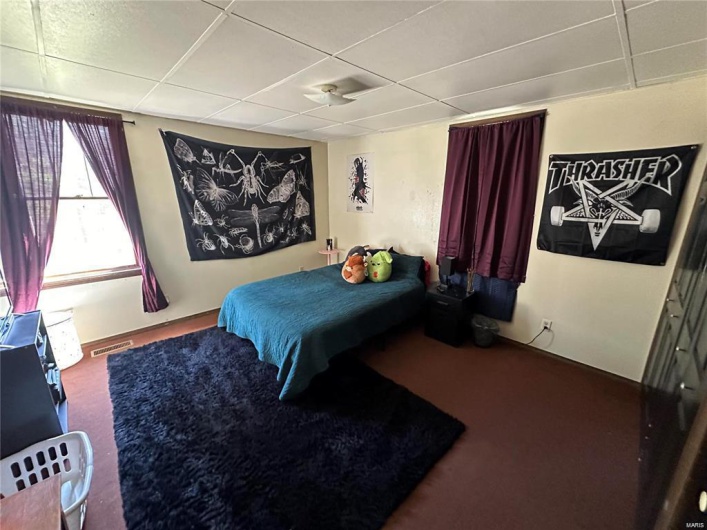 Bedroom with a paneled ceiling