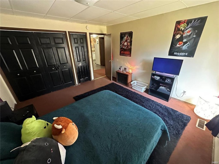 Bedroom with carpet and a closet