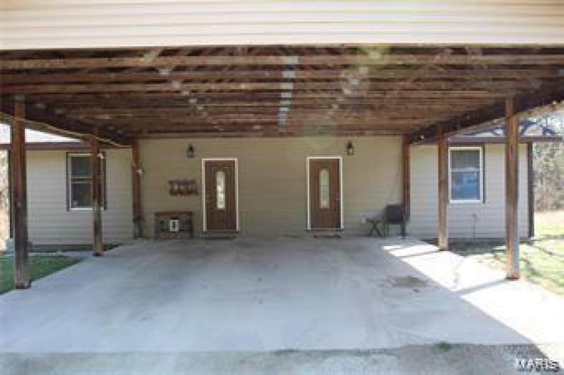 View of patio with a carport