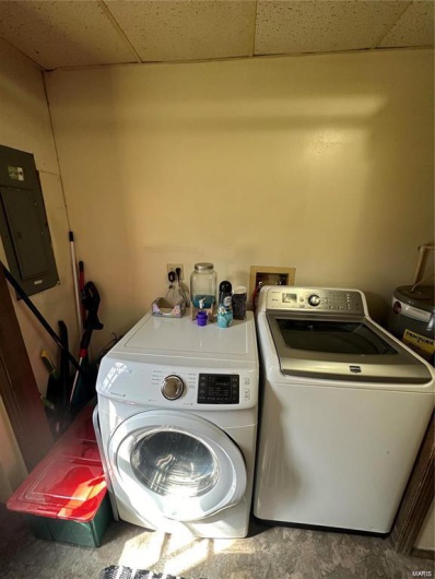 Washroom featuring washing machine and dryer and electric panel