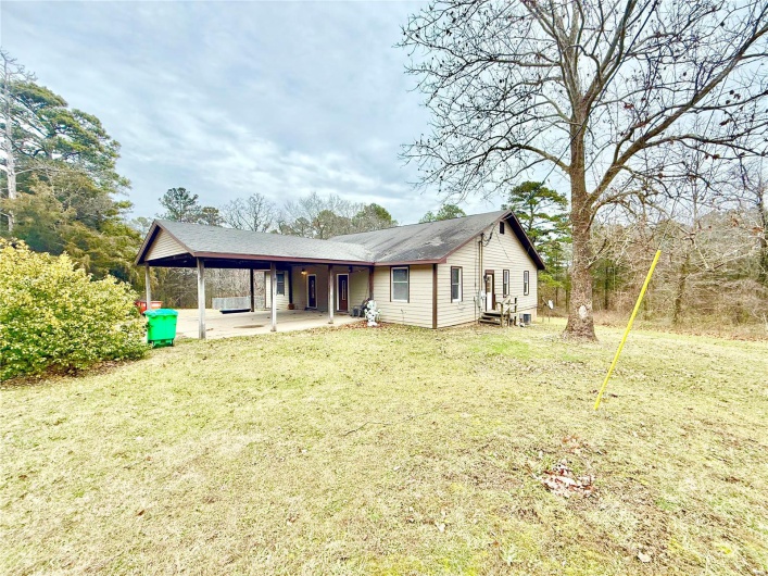 Rear view of house featuring a lawn and a patio area