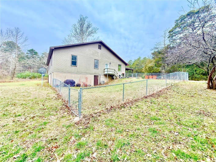 Rear view of property featuring a yard