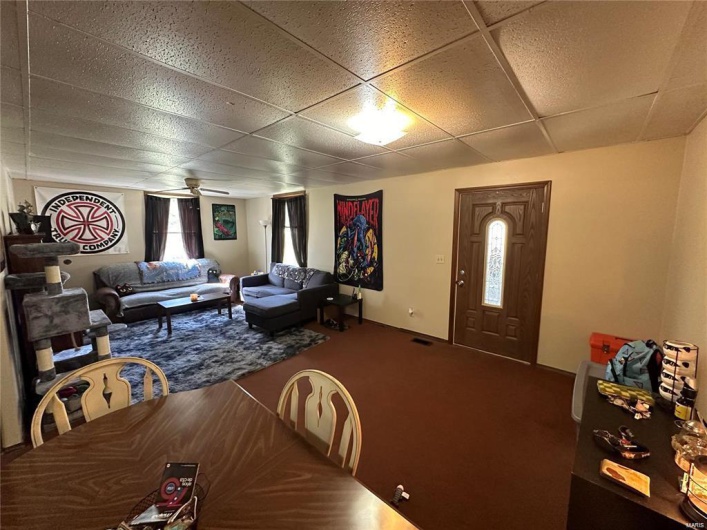 Dining area with a drop ceiling and ceiling fan