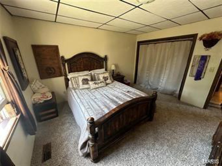 Carpeted bedroom with a closet