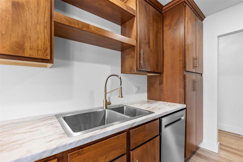 Kitchen with dishwasher,  light hardwood/wood-style floors, and sink