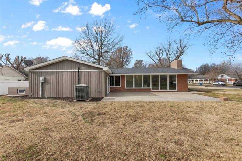 Rear view of house featuring a patio, a lawn, and central air condition unit