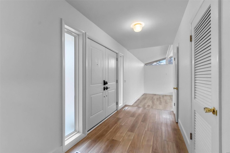 Corridor with light hardwood/wood-style flooring
