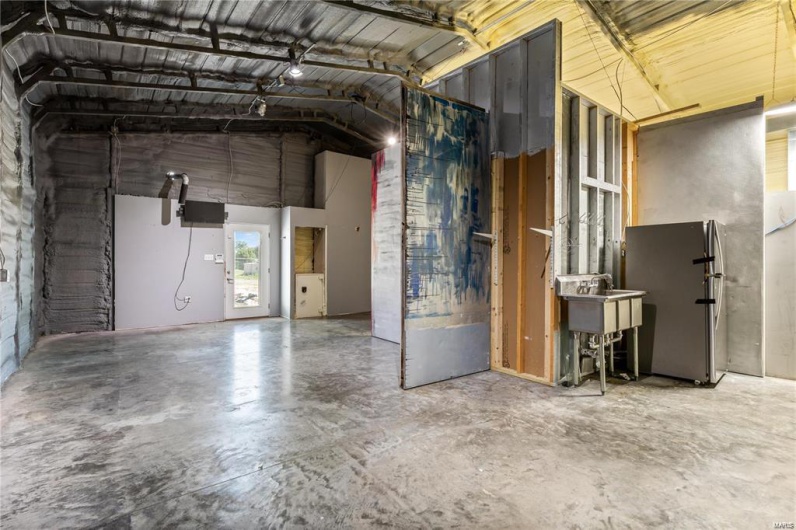 Garage featuring stainless steel fridge