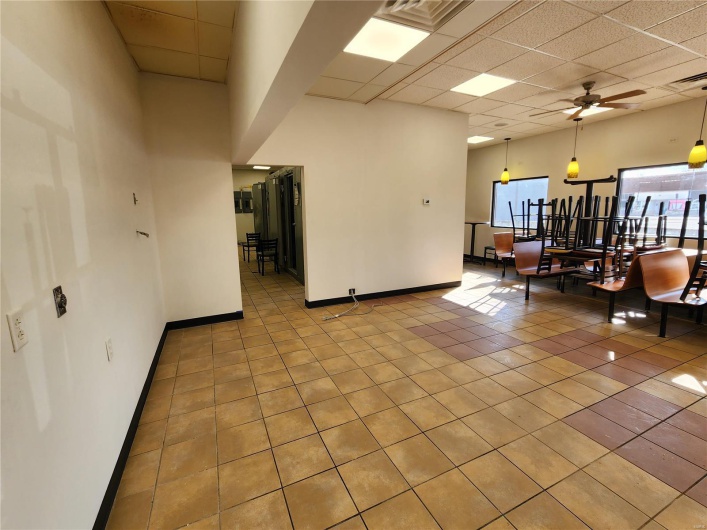 Tiled spare room featuring a paneled ceiling and ceiling fan