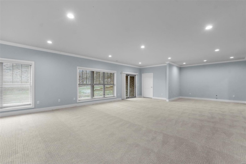 Empty room with light colored carpet and ornamental molding
