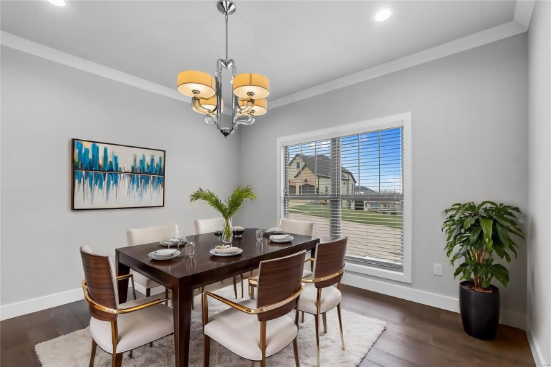 Dining room featuring a chandelier, dark hardwood / wood-style floors, and crown molding