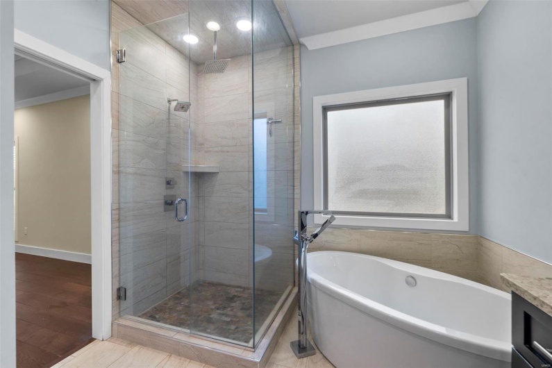 Bathroom featuring tile patterned flooring, vanity, ornamental molding, and independent shower and bath