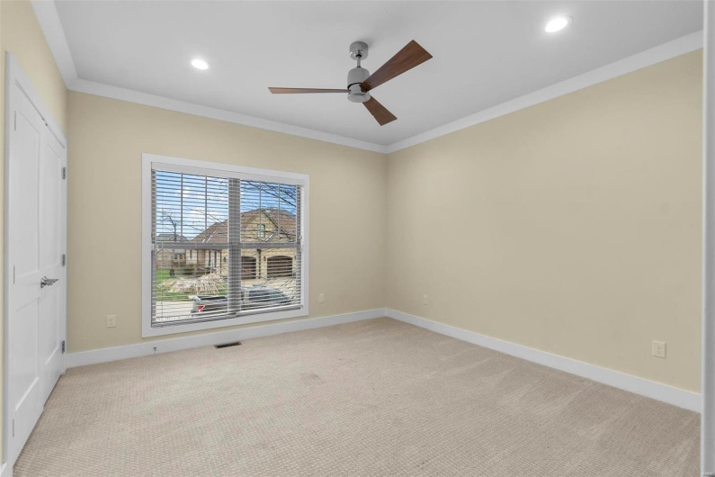 Unfurnished room with light carpet, ceiling fan, and ornamental molding