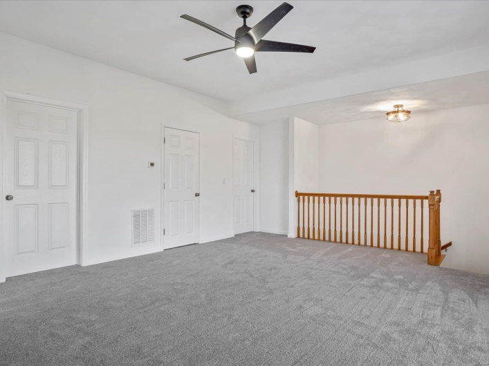 Spare room featuring ceiling fan and carpet floors