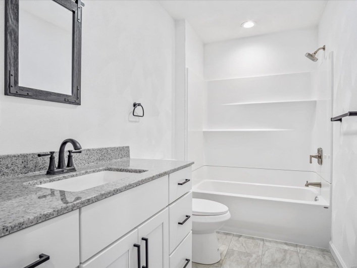 Full bathroom featuring vanity, toilet, and shower / washtub combination