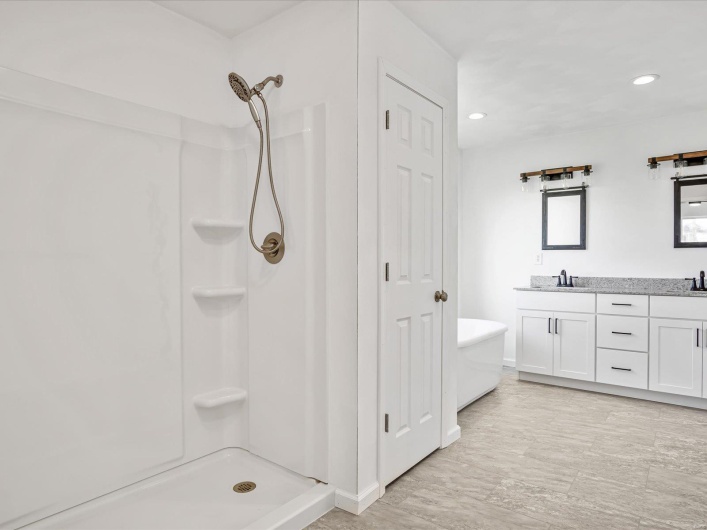 Bathroom featuring vanity and shower with separate bathtub