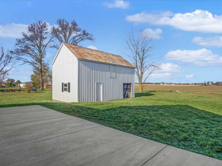 View of outdoor structure featuring a yard