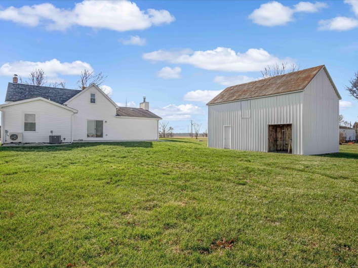 View of yard with an outbuilding, cooling unit, and ac unit