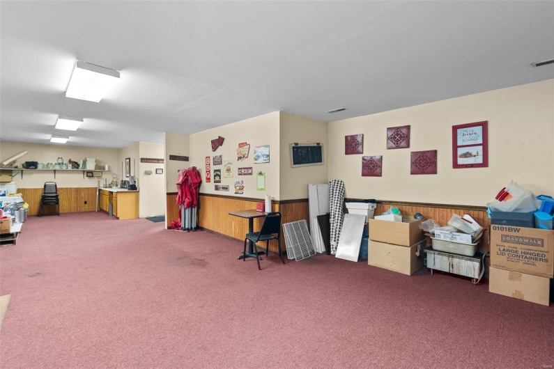 Misc room featuring carpet floors and wooden walls