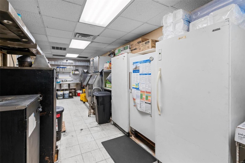 Kitchen with a paneled ceiling and white fridge
