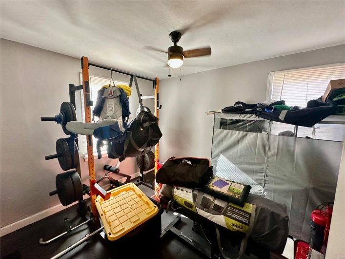 Workout room featuring ceiling fan