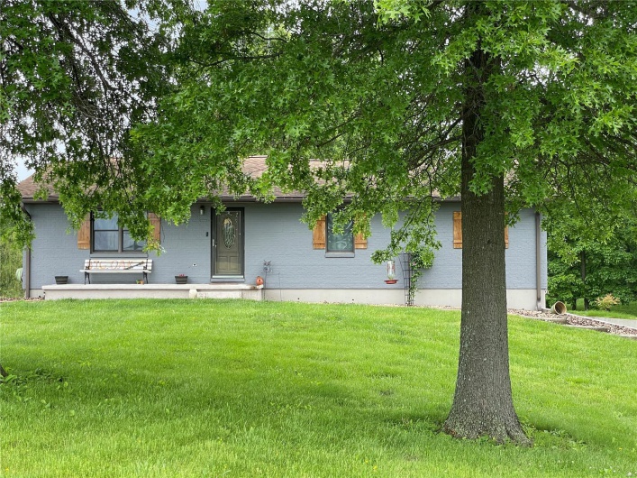 View of front of property with a front yard and brick siding