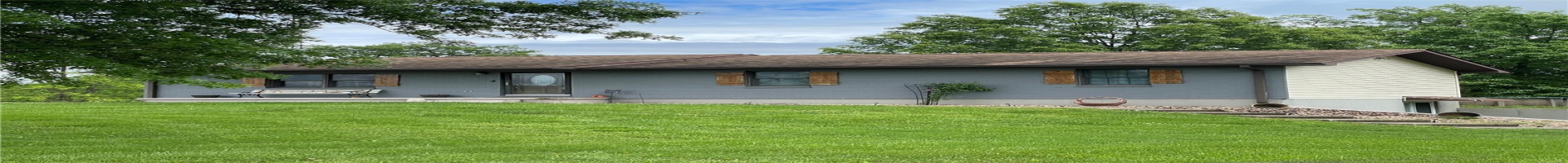 Residential For Sale Rear view of house with a yard, a shingled roof, and brick siding