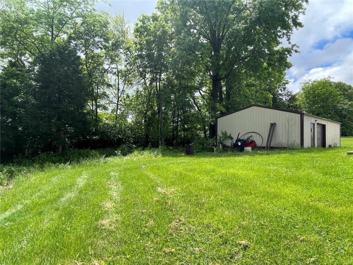 View of side of property featuring a lawn