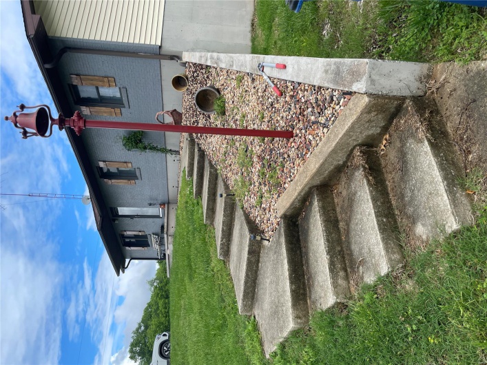 Property entrance featuring brick siding and a yard