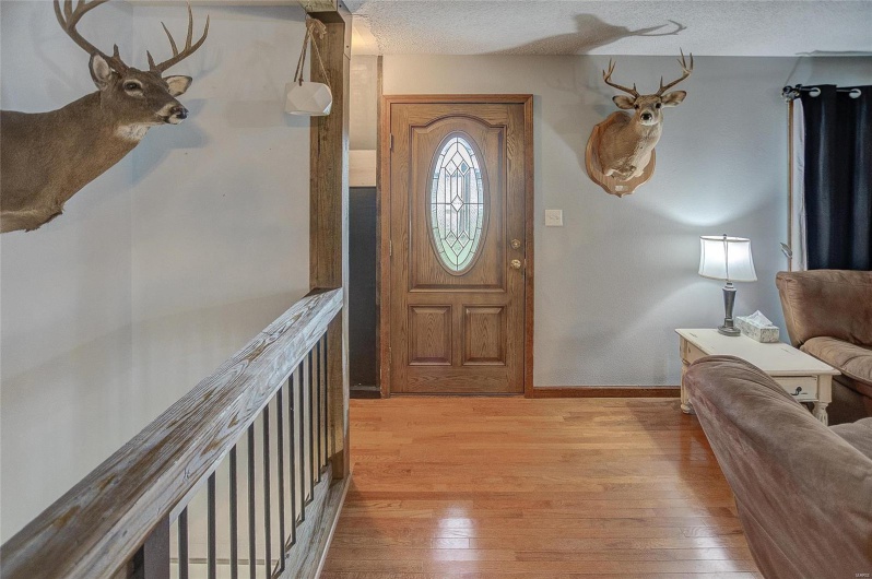 Entryway featuring light hardwood / wood-style floors and a textured ceiling